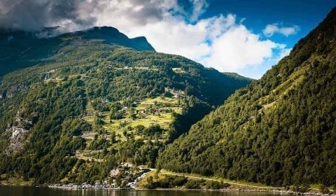 View towards to zig-zag Eagle Road going up to mountains in Geiranger, Norway