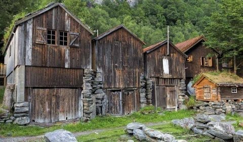 Old wooden cabins on the road side in the mountains towards the Herdal Goat Farm in Geiranger