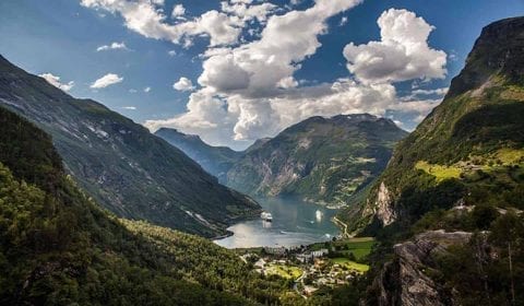 View over Geiranger, the Geirangerfjord and the Eagle Road from Flydalsjuvet on a semi cloudy day