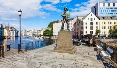 Statue of Fiskergutten, fisherman's son, at the Brosund canal in the Art Nouveau city of Ålesund, Norway.