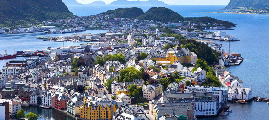 View from Mount Aksla over the center of Ålesund, colourful Art Nouveau buildings on several islands, peacefully surrounded by the Atlantic Ocean