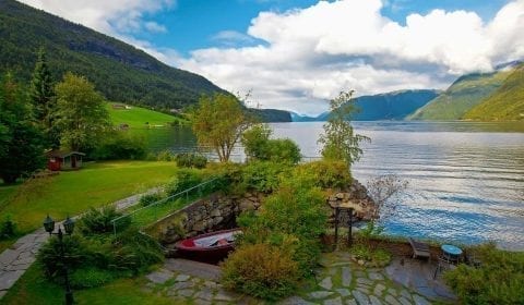 The deepest lake in Europe, Hornindalsvatnet, surrounded by green mountains on the road from Hellesylt to Geiranger, Norway