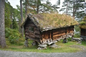 A traditional Norwegian wooden building with grass roof at the Sunnmøre Museum in Ålesund, Norway