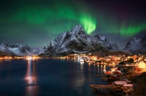 The Northern lights over a fishing village in Lofoten, Norway