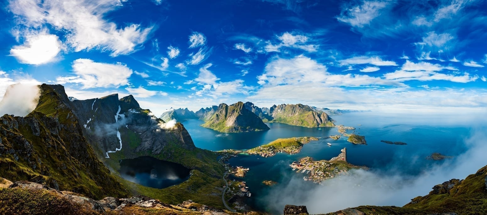 A view of mountains emerging from the ocean in Lofoten, Norway.