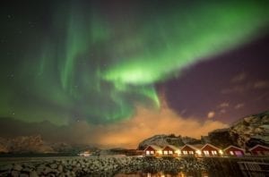 The Northern lights over a fishing village near Leknes, Norway.