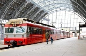 A view inside a train station in Bergen, Norway with train in foreground.