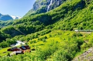 A view of the flåm train traveling through the beautiful Norwegian countryside.