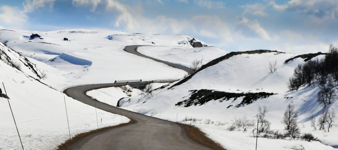 a windy road through a snowy landscape to get to a cabin, Norway.