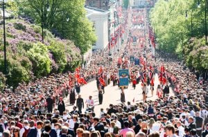 A view of a large crowd watching the Syttende Mai parade in Oslo, Norway pre-pandemic.