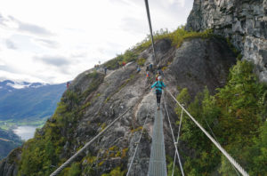 A woman walks across the via ferrata bridge in Loen, Norway.