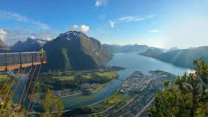 A view of Rampestreken viewing platform and the Romsdal valley, mountains, and fjord below.